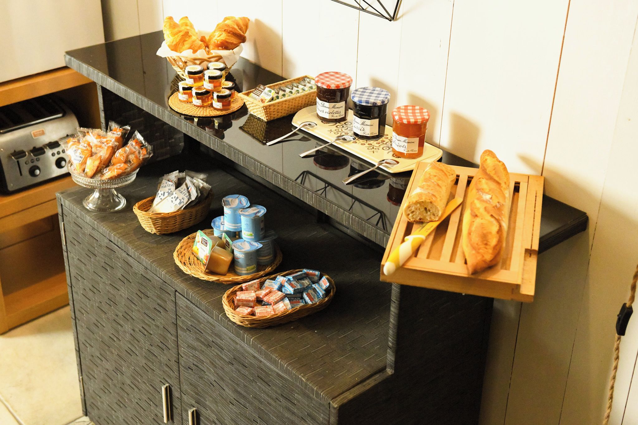 A kitchen counter with various food items and condiments.