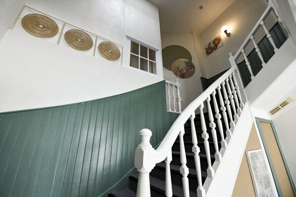 A staircase with white balusters and a green wall. - Hotel le Coureau (Saint-Trojan-les-Bains)