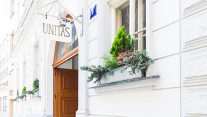 A building with a sign reading "UNITAS" and a number "9" on the wall. - Unitas Residence (Prague)