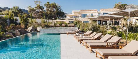 Seasonal outdoor pool, open 7:00 AM to 7:00 PM, pool umbrellas