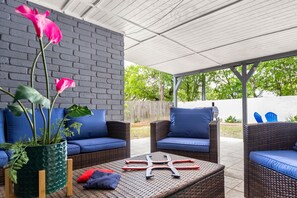 Relax in a serene outdoor space with comfortable seating and a natural touch.