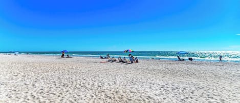 Na praia, espreguiçadeiras, toalhas de praia