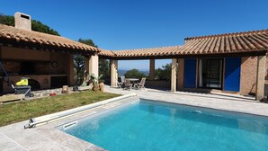 A pool area with a patio, outdoor seating, and a view of the landscape. - Magnificent pool villa between sea and mountains (Céret)