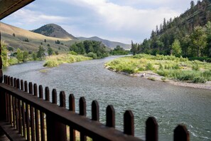 A river flowing through a valley with hills and trees.