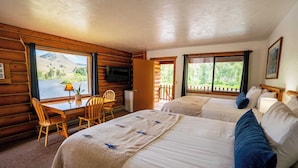 A log cabin room with two beds, a desk, and a TV. - River's Fork Lodge (North Fork)