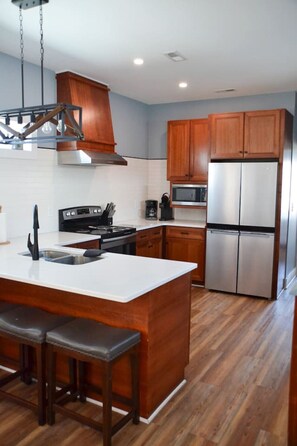 Enjoy cooking in this well-equipped kitchen with a central island and stainless steel appliances.