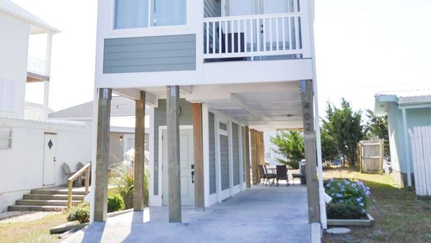 A two-story building with a balcony on the upper floor. - Unique 3BR Home with great views Beach Access (Atlantic Beach)