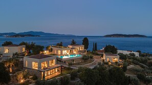 A coastal property with multiple modern houses, a swimming pool, and a view of the sea and distant islands. - Pelagoon Skiathos (Skiathos)