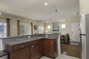 Enjoy cooking in this well-equipped kitchen with a large island, television, and comfortable seating area.
