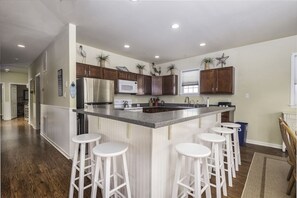 Enjoy cooking in this well-equipped kitchen with a central island and ample storage.