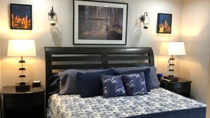 A neatly arranged bedroom with a bed, two bedside tables, a ceiling fan, and framed artwork on the walls. - Amazing Five-Star Luxury Thornton Park two Bedroom Apt - close to Kia Center. (Orlando)
