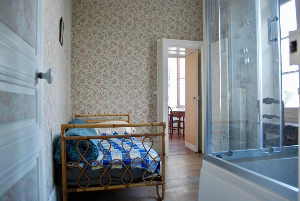 A room with a bed, a door, and a window.