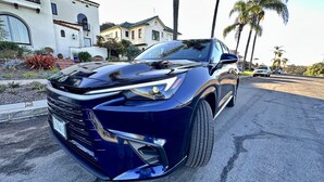 A modern car parked in a driveway with a house in the background. - 3blocks2beach, Free Parking, A/C, Fast Wifi (San Diego)
