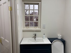 A bathroom with a white sink, a window, and a toilet. - Vauxhall Victorian Building Sleeps 3 (London)