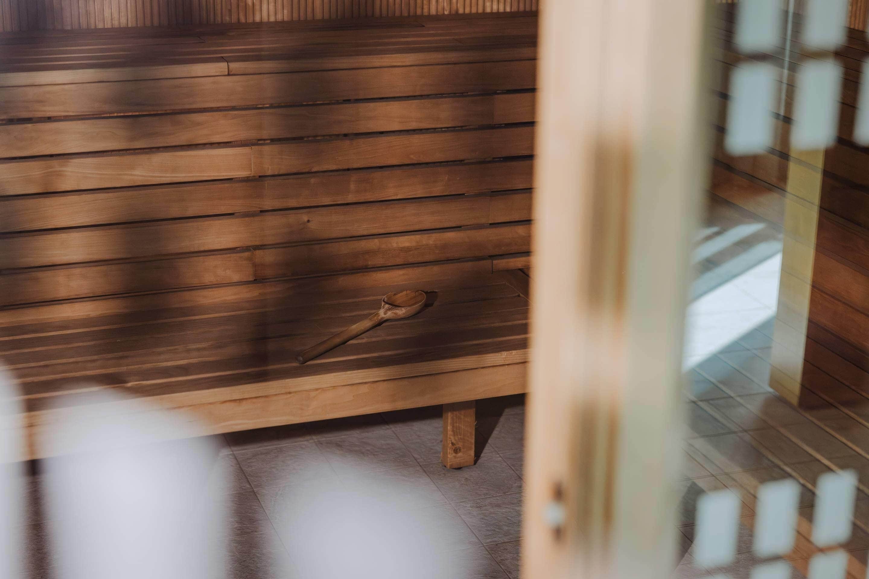A wooden bench with a key on it, suggesting a secure entry point to a room.