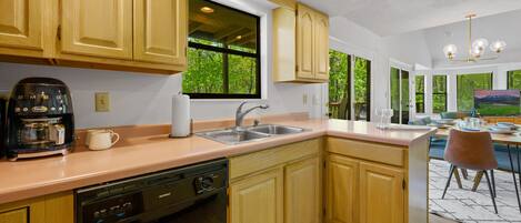 Prepare meals in the spacious kitchen with a large island, sink, and ample counter space.