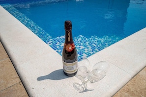 A bottle of wine and wine glasses by the poolside. - Lovely 3-bed Villa in Istria Villa Flegar (Svetvincenat)