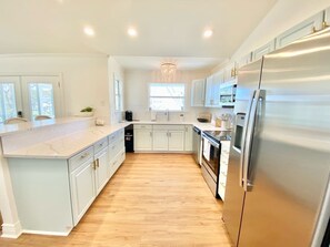 Fridge, coffee/tea maker, cookware/dishes/utensils - Cheerful 2-Bedroom Home on the Water with a Pool (Pass Christian)