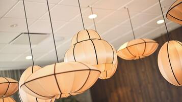A ceiling with multiple spherical pendant lights.