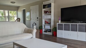 Relax in this stylish living room with a sofa, coffee table, and flat-screen TV.