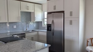 Enjoy cooking in this well-equipped kitchen with a stainless steel refrigerator, oven, and dishwasher.