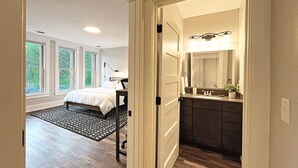 A bedroom with a bed, a desk, and a window. - Historic & Modern! Walk to Restaurants, Moccasin Springs + Huge Suite w/ Kitchen (Hot Springs)