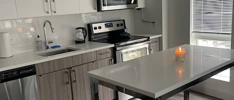 Microwave, dishwasher, coffee/tea maker, cookware/dishes/utensils