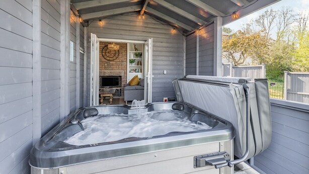A covered outdoor hot tub area with a built-in TV and seating. - 2 bedroom accommodation in Bakewell (Bakewell)