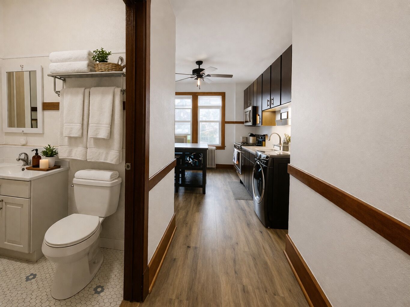 A modern bathroom with a toilet, sink, and towel rack.