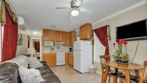 A compact living space with a kitchenette, a dining area, and a seating area.
