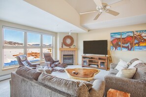 Relax in this cozy living space with a fireplace, flat-screen TV, and comfortable seating for two.