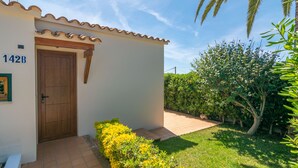 A building with a tiled roof, a wooden door, and a number '142B' on the wall. - VILLA VICTORIA - Charming house with shared pool. (Alaior)