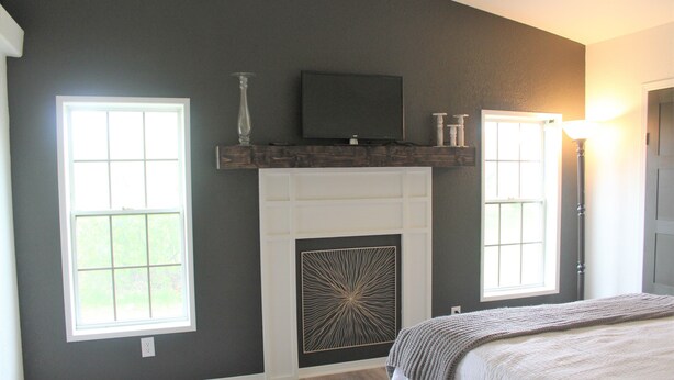 A bedroom with a fireplace, two windows, a television, and a lamp. - Edward House, on 7 acres, not far from Notre Dame & Golf Course (Walkerton)