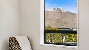 A room with a large window offering a mountain view. - Central Queenstown Villa & Spa (Queenstown)