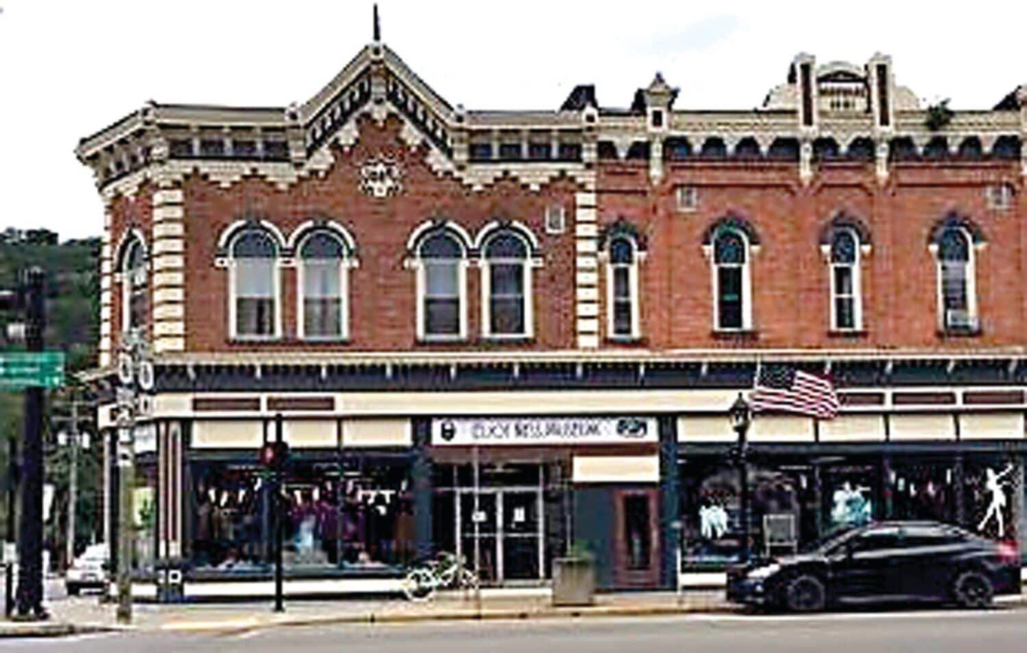 A historic building with a classic architectural style, featuring arched windows and decorative brickwork.
