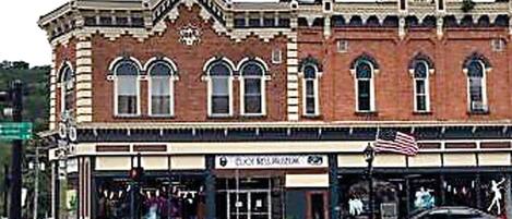 A historic building with a classic architectural style, featuring arched windows and decorative brickwork.