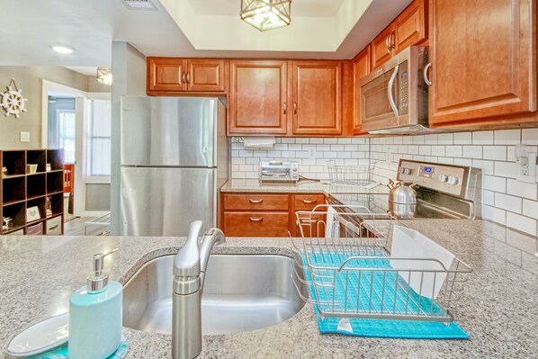 Enjoy cooking in this fully equipped kitchen with a refrigerator, microwave, and oven.