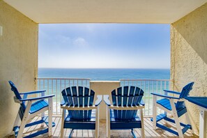 Enjoy ocean views from this balcony with a seating area.