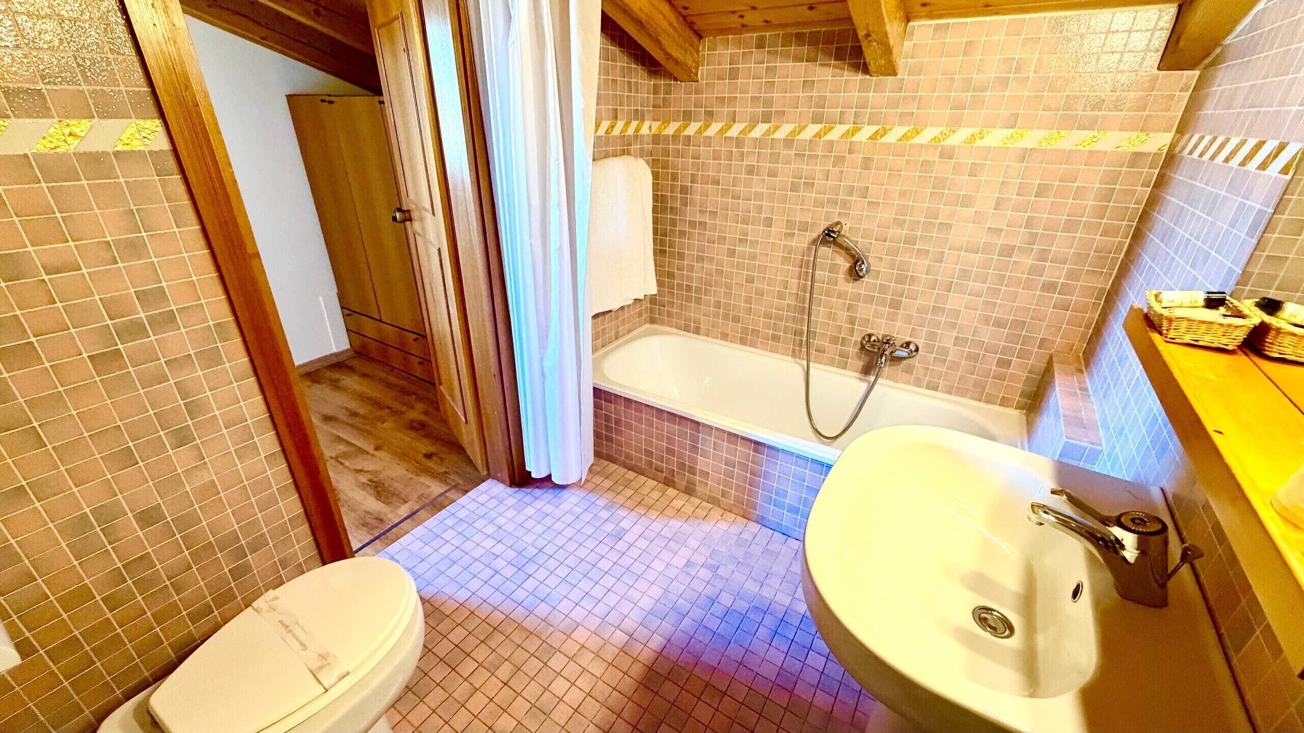 Un baño con bañera, inodoro y lavamanos.