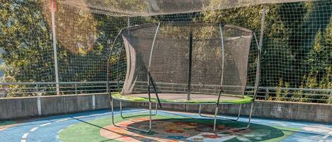 A playground with colorful play equipment and a soccer ball.
