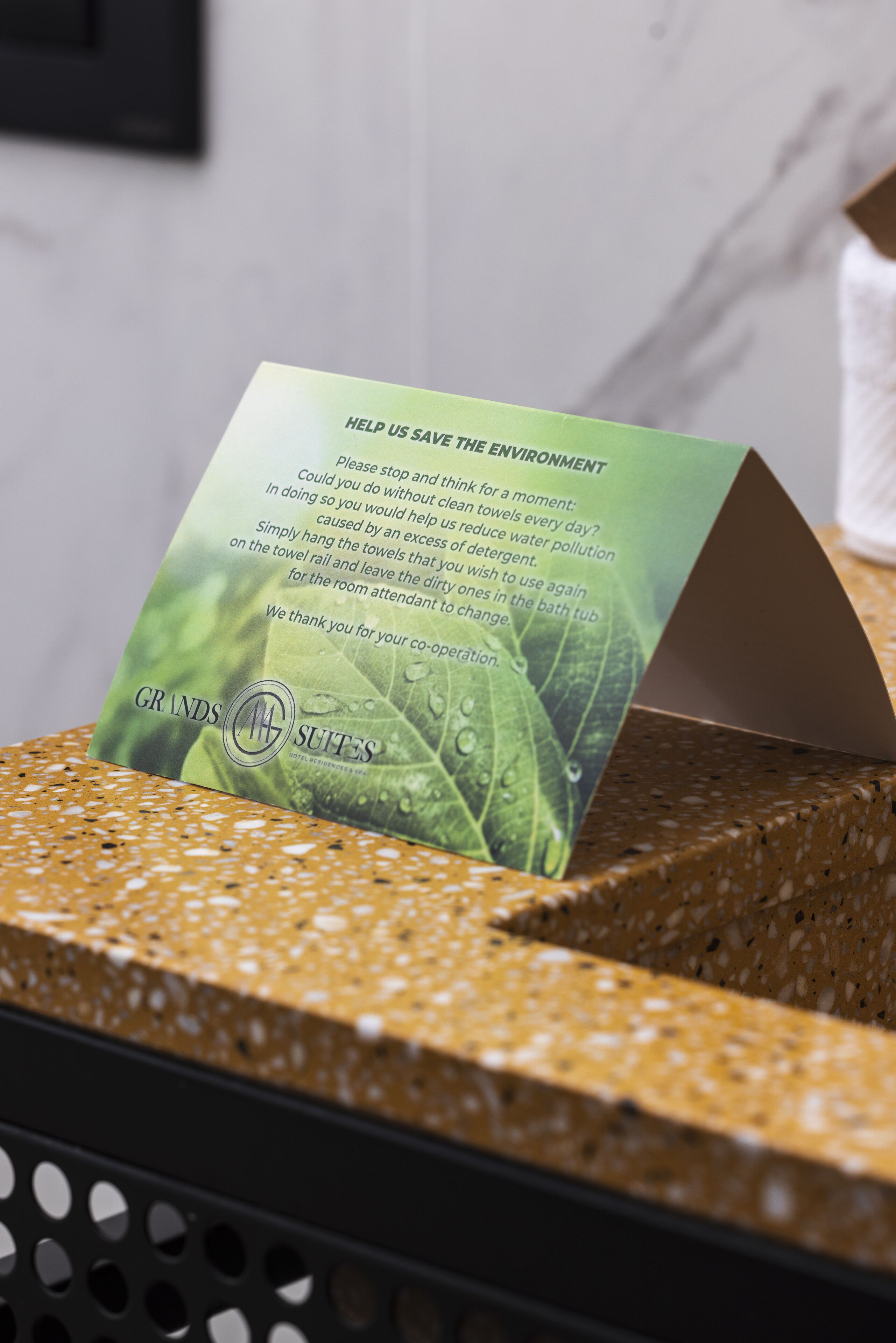 A green informational card in a basket, promoting environmental awareness.
