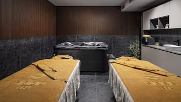 Relax in a serene spa room with a massage tub and two massage tables.