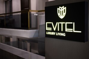 A sign for 'EVITEL LUXURY LIVING' with a modern, illuminated logo. - Evitel Luxury Living (Kassandra)