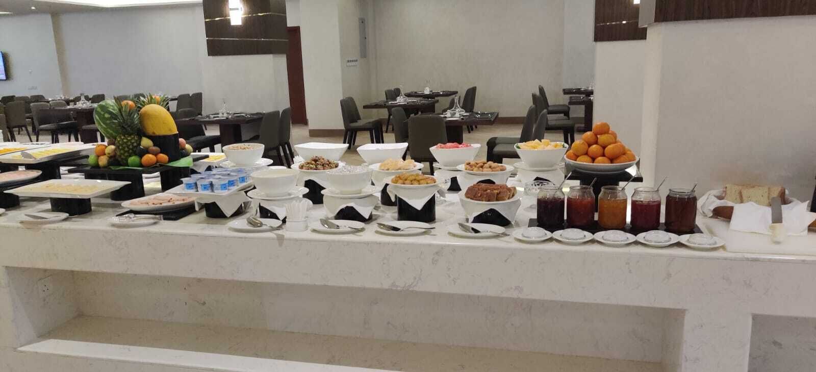 A buffet setup with various food items and condiments.