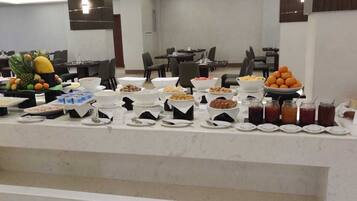A buffet setup with various food items and condiments.
