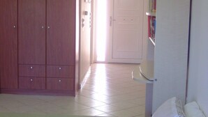 A bedroom with a bed, a wardrobe, a bedside table, and a bookshelf. - Remarkable 1-bed Apartment in (Chalcis)
