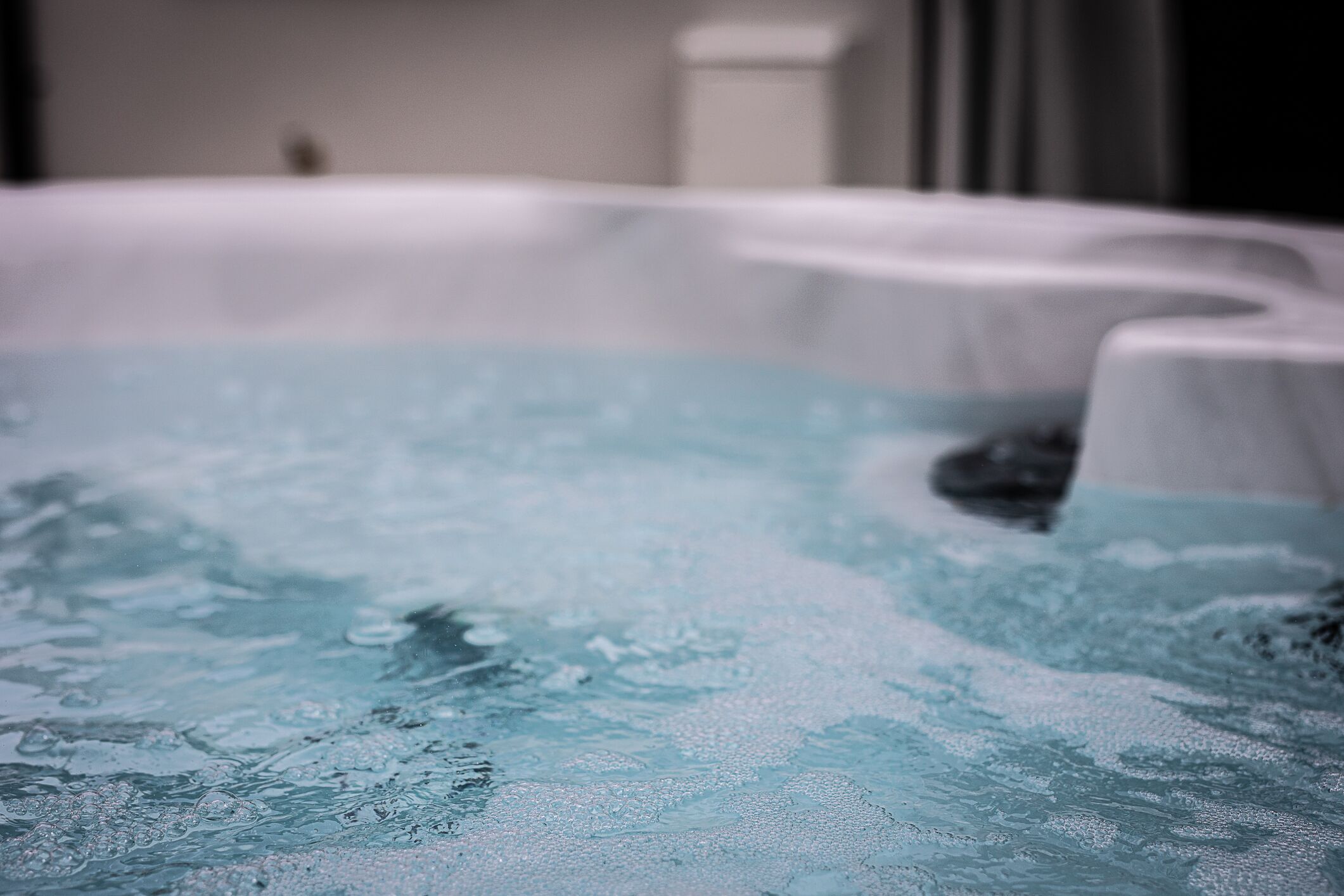 A hot tub with a curved edge and a white interior.