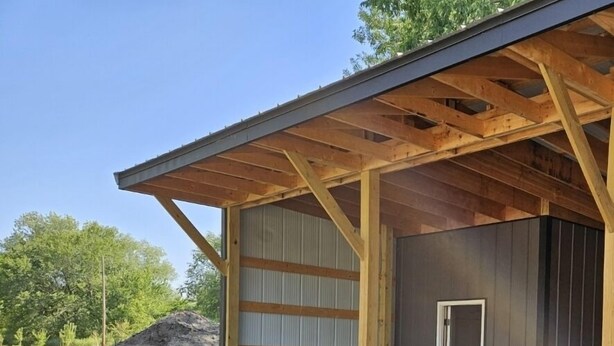 A building with a wooden roof and a corrugated metal wall. - Cozy house  close to public land areas for recreation! (West Mineral)