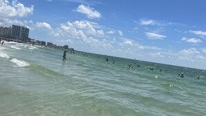 A beach with clear water and a few people swimming. - Private Pool and Close to Clearwater beach! Perfect for any family! (Clearwater)