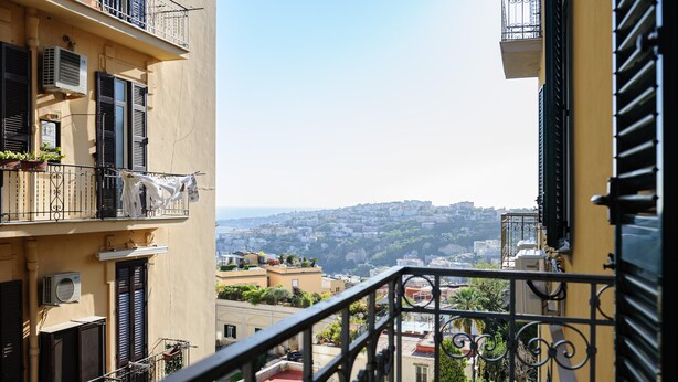 A balcony with a view of a cityscape, featuring multiple buildings and a clear sky. - Via Aniello Falcone 72b (Naples)